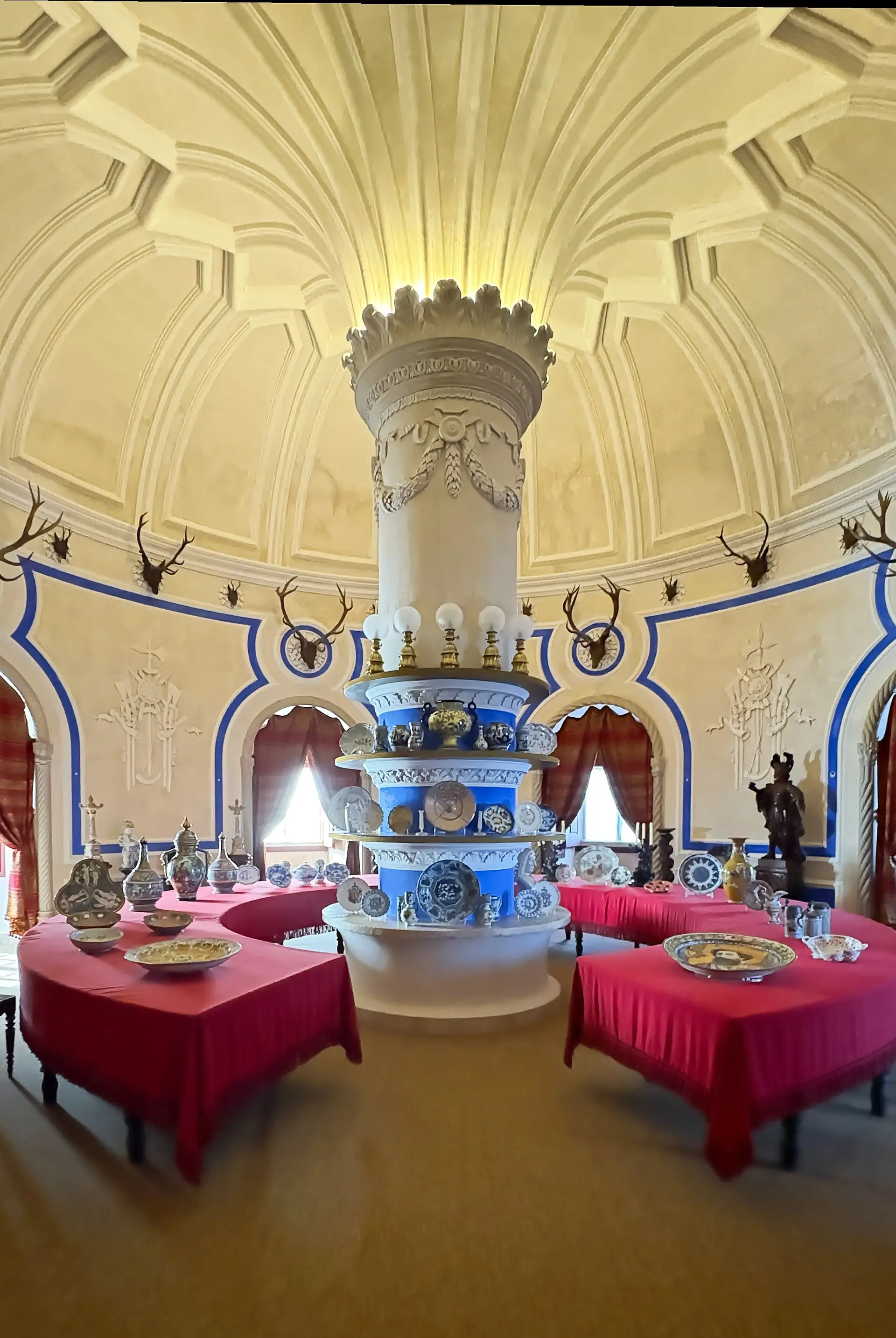 The round Stag Room in the Pena Palace with a central column and laid tables