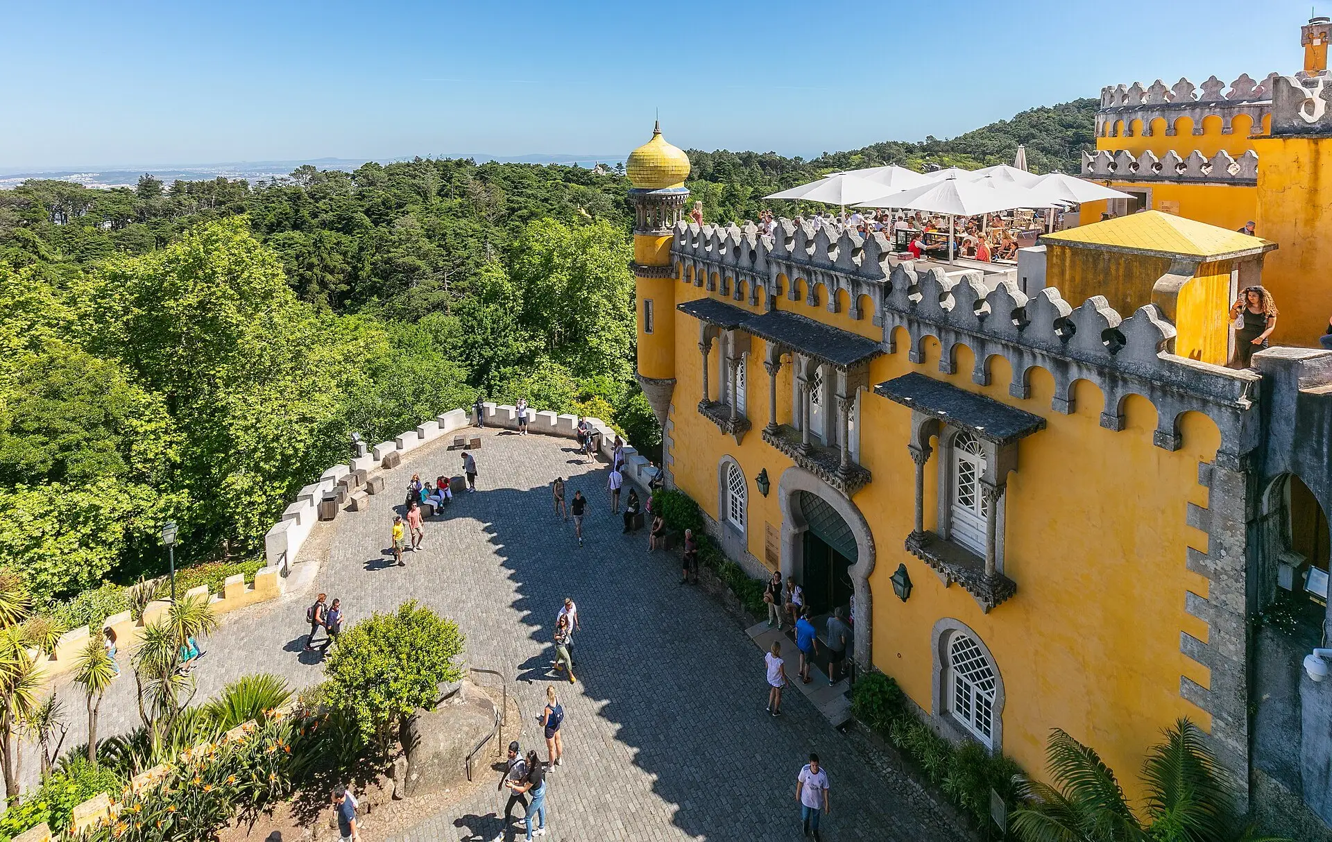 The yellow arcaded terrace of the Pena Palace with the forest of Sintra below