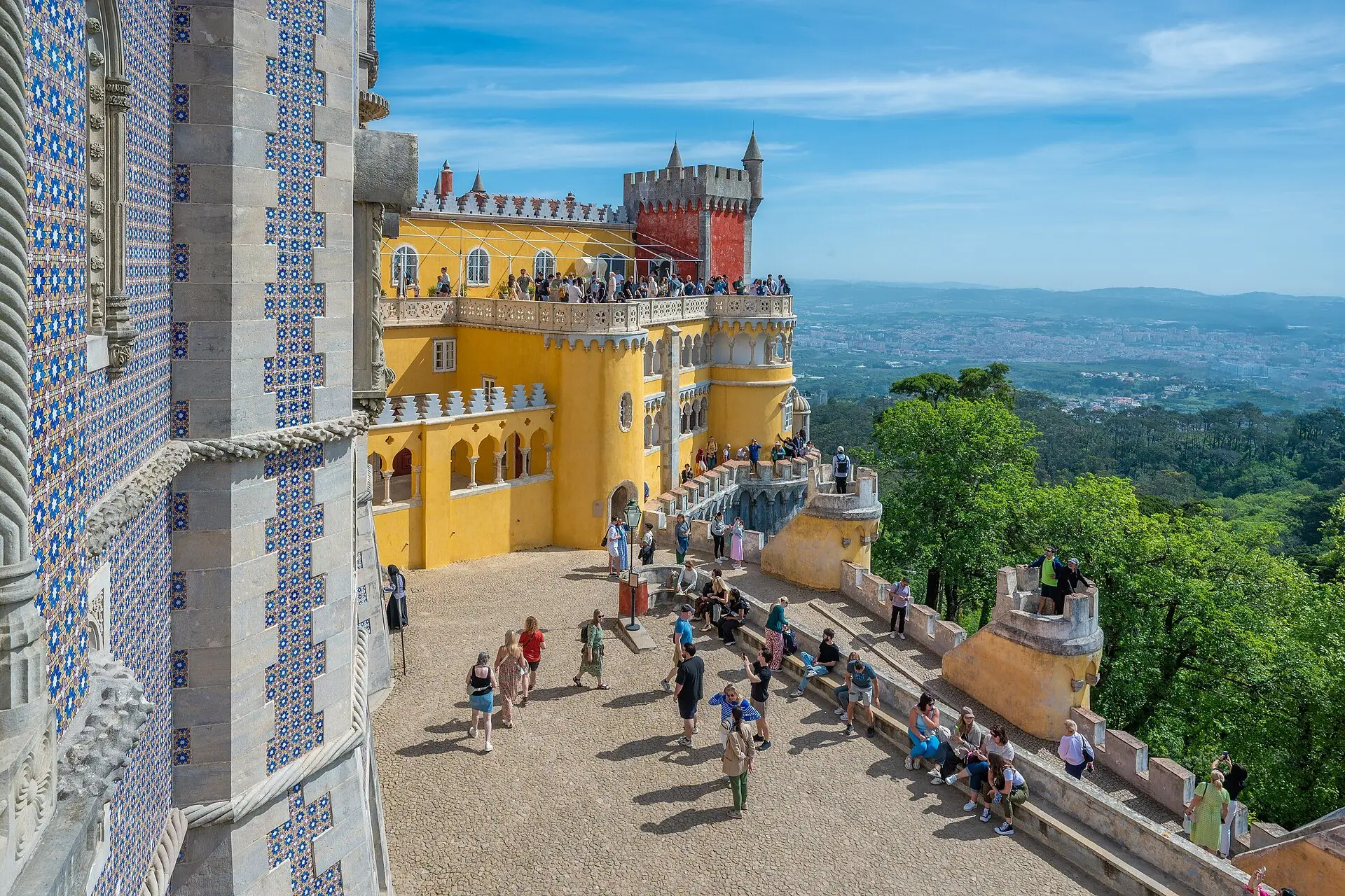 Visitors on the yellow terraces of the Pena Palace during opening hours