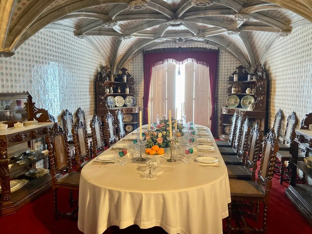 The dining room of the Pena Palace with its long laid table under a vaulted ceiling