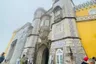 Visitors at the Triton facade on a misty day