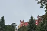 The red walls of the Pena Palace above the forest
